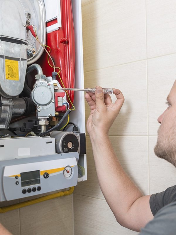 Technician repairing Gas Furnace.